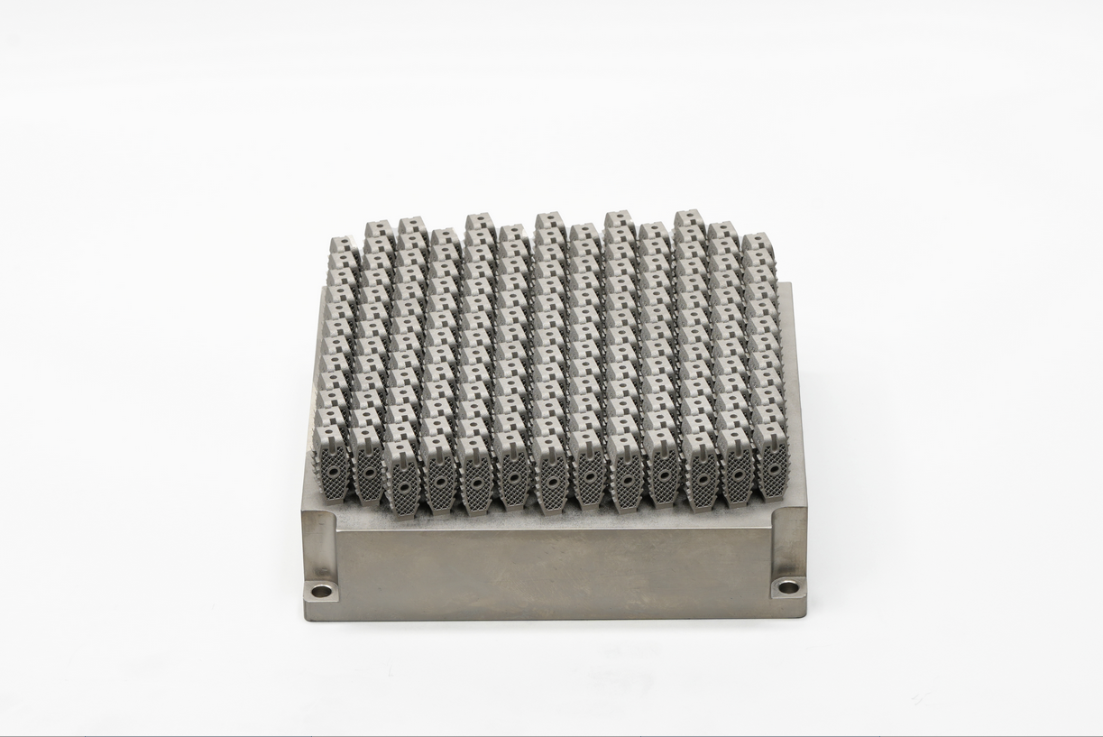 High-density nest of porous metal additive spinal cage blanks on a build plate