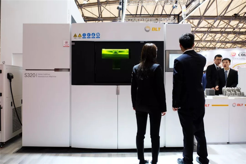 S320-class metal additive manufacturing system displayed at a tradeshow