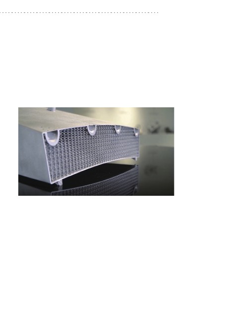 Metal additive lattice-channel heat-exchanger segment blank on a reflective table