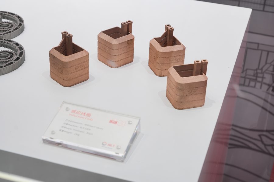 Four copper additive square induction coils on an exhibition table